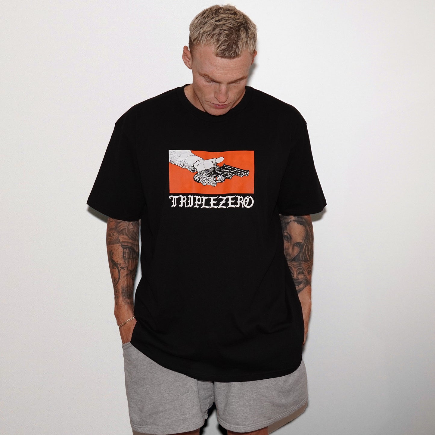 model wearing black tshirt with orange print